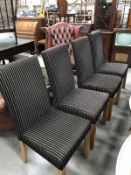 A set of 4 upholstered dining chairs.