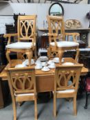 An extending dining table with 2 leaves and a set of 6 chairs.