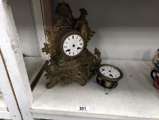 A mantel clock with spare movement for spare or repair.