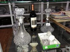 3 glass decanters, 3 spare stoppers and a bottle of wine.