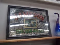 A framed Jameson's whisky advertising mirror.