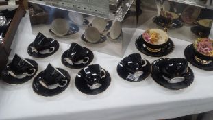 A Black Glazed Adderley Floral & Aynsley Tea Cups And Saucers