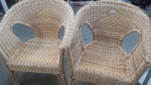 A pair of cane conservatory arm chairs