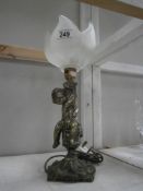 A figural lamp featuring a cherub and a glass tulip style shade