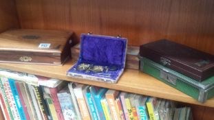 A collection of boxes including a traders coin box, a small weighing scale set etc.