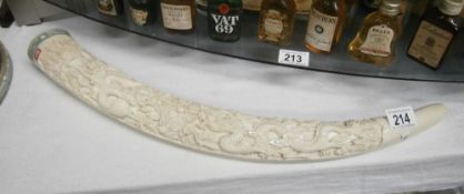 A replica carved tusk (probably resin).