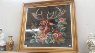 A large framed and glazed needlepoint of a stag