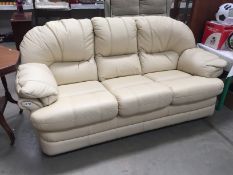 A cream 3 seater leather settee