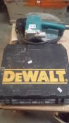 A DeWalt drill and a Mikita belt sander