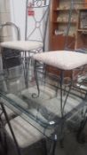 A Glass Topped Steel Framed Table And 6 Chairs.