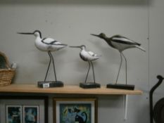 3 sea bird figures.