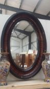 A large frramed oval mirror