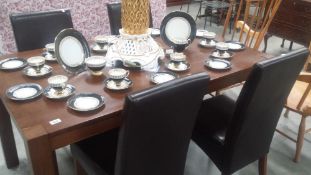 A darkwood dining table and 4 chairs