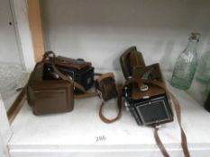 A cased Ricohmatic 225 camera and a cased Photina reflex camera