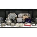 A shelf of plated metalware including trays, napkin trays etc.