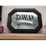 An oak framed mirror advertising D.W.D.