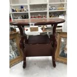 A mahogany oval top magazine rack coffee table