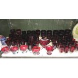 A large quantity of ruby glass drinks glasses