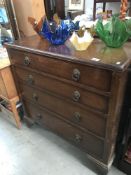 A 4 drawer dark wood chest