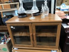 A teak effect glazed TV cabinet stand