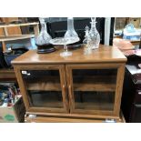 A teak effect glazed TV cabinet stand