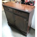 A Darkwood stained 2 drawer 2 door hall cupboard