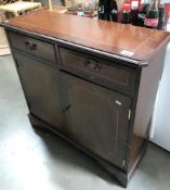 A Darkwood stained 2 drawer 2 door hall cupboard