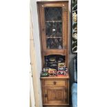 A leaded glazed oak narrow wall unit