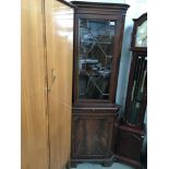 An astragal glazed corner cupboard