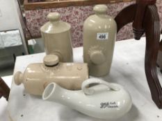 3 stoneware foot warmers and a boots bottle