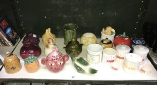 A shelf of novelty preserve pots including Sylvac and Hornsea