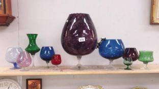 A large coloured brandy glass and 9 others