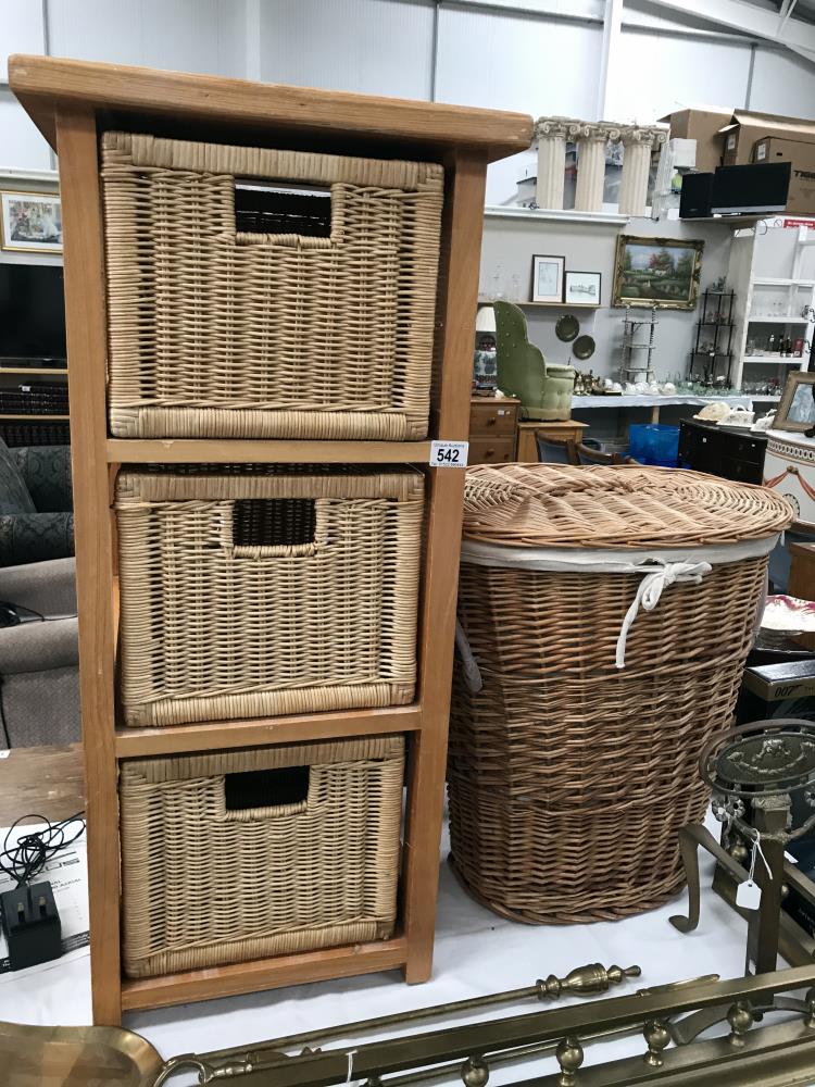 A bathroom chest with wicker drawers and a linen basket