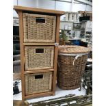 A bathroom chest with wicker drawers and a linen basket
