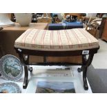 A darkwood stained dressing table stool with lyre ends