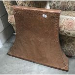 A hammered copper breast chimney front