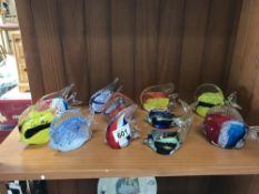 A quantity of glass fish paperweights etc.