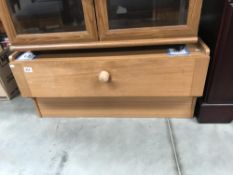 A teak effect TV stand with drawer