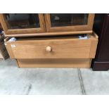 A teak effect TV stand with drawer