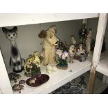 A shelf of figures & animal ornaments