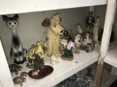 A shelf of figures & animal ornaments