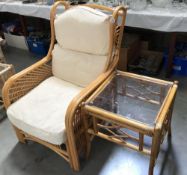 A bamboo conservatory chair and glass top table