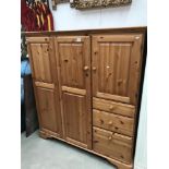 A modern solid pine Ducal cupboard with drawers