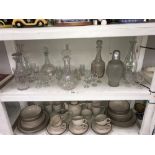 A shelf of glass decanters & drinks glasses