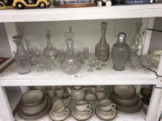 A shelf of glass decanters & drinks glasses