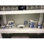 A shelf of blue & white pottery including jugs,