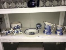 A shelf of blue & white pottery including jugs,