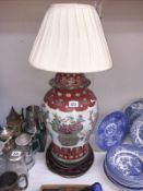 A large oriental lidded jar converted to table lamp with old repair