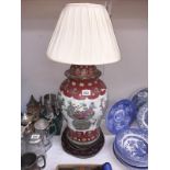 A large oriental lidded jar converted to table lamp with old repair