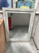 A large painted bevel edge mirror